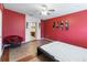 View of main bedroom with red walls, tile floors and attached ensuite bathroom at 3000 Laurel Park Ln # 308, Kissimmee, FL 34741