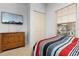 Cozy bedroom with a dresser, a TV, and a window with a view at 3203 Oyster Ln, Kissimmee, FL 34747