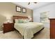 Comfortable bedroom showcasing a queen bed, two bedside tables, and a window for natural light at 3203 Oyster Ln, Kissimmee, FL 34747