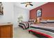 Bright bedroom with two twin beds, colorful decor, and a ceiling fan at 3203 Oyster Ln, Kissimmee, FL 34747
