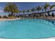 Large community pool with lounge chairs and palm trees around the deck at 3203 Oyster Ln, Kissimmee, FL 34747