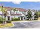 Charming townhouse with light blue siding, brown shutters, palm trees, and convenient parking at 3203 Oyster Ln, Kissimmee, FL 34747