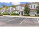 Charming townhouse with light blue siding, brown shutters, landscaping, and convenient parking at 3203 Oyster Ln, Kissimmee, FL 34747