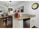 Cozy kitchen area featuring a stainless steel dishwasher, granite countertops, and seating at 3203 Oyster Ln, Kissimmee, FL 34747