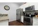 Modern kitchen with stainless steel appliances, granite countertops, and ample storage space at 3203 Oyster Ln, Kissimmee, FL 34747