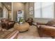 Inviting lounge area with leather armchairs, a unique wicker coffee table, and a convenient vending machine at 3203 Oyster Ln, Kissimmee, FL 34747