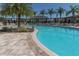 Beautiful community pool featuring inviting lounge chairs and lush palm trees, perfect for relaxation at 3203 Oyster Ln, Kissimmee, FL 34747