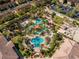 Aerial view of the community pool area featuring lush landscaping and resort-style amenities at 3214 Calabria Avenue, Davenport, FL 33897