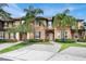 Attractive townhome with tropical landscaping and a brick driveway at 3214 Calabria Avenue, Davenport, FL 33897