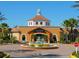 Beautiful building exterior with manicured grounds, fountain, and palm trees for a resort-like experience at 3214 Calabria Avenue, Davenport, FL 33897