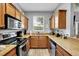 Efficient kitchen with wood cabinetry and granite countertops at 3214 Calabria Avenue, Davenport, FL 33897