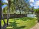 Private backyard featuring lush lawn, mature trees and an ivy covered privacy wall at 3307 Kentshire Blvd, Ocoee, FL 34761