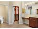 Bathroom featuring a vanity area, wood cabinets, tile flooring, and a walk-in closet at 3307 Kentshire Blvd, Ocoee, FL 34761