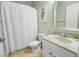 Bathroom with a shower, decorative mirror, white vanity, and neutral green walls at 3307 Kentshire Blvd, Ocoee, FL 34761