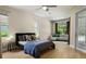 Spacious bedroom features an en-suite sitting area, multiple windows, wood flooring, and stylish decor at 3307 Kentshire Blvd, Ocoee, FL 34761