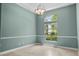 Bedroom featuring chair rail molding, tile floors, neutral color scheme, and a bright window at 3307 Kentshire Blvd, Ocoee, FL 34761