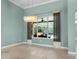Dining Room featuring a large window, tray ceilings and stunning light fixture at 3307 Kentshire Blvd, Ocoee, FL 34761