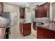 Spacious kitchen featuring stainless steel appliances, a center island, and tile flooring at 3307 Kentshire Blvd, Ocoee, FL 34761