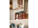 Kitchen breakfast bar with two dark-stained wood stools with blue padded seats at 3307 Kentshire Blvd, Ocoee, FL 34761