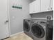 Well-equipped laundry room with washer, dryer, storage cabinets, and modern fixtures at 3307 Kentshire Blvd, Ocoee, FL 34761