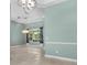 Bright living room features stylish lighting and light-colored tile flooring, complemented by pale blue walls at 3307 Kentshire Blvd, Ocoee, FL 34761