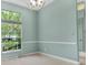 Light blue living room filled with lots of natural light from a large window, plus stylish crown molding at 3307 Kentshire Blvd, Ocoee, FL 34761