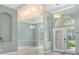 Light filled living room showcasing a neutral color scheme, tile flooring and a stunning chandelier at 3307 Kentshire Blvd, Ocoee, FL 34761