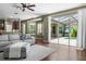 Bright living room featuring hardwood floors, access to the lanai, and views of the screened-in pool at 3307 Kentshire Blvd, Ocoee, FL 34761