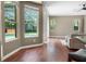 Bright living room with hardwood floors and views of the screened patio and pool at 3307 Kentshire Blvd, Ocoee, FL 34761