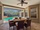 Covered patio with ceiling fan and dining set adjacent to a screened-in pool and spa at 3307 Kentshire Blvd, Ocoee, FL 34761