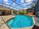 Enclosed in a screen, this pool features a hot tub and a patio dining set outside of the home at 3307 Kentshire Blvd, Ocoee, FL 34761