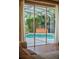 View of the screened in pool and hot tub through large sliding glass doors at 3307 Kentshire Blvd, Ocoee, FL 34761