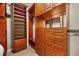 Spacious walk-in closet with custom wood shelving and drawer systems for ample storage space at 3307 Kentshire Blvd, Ocoee, FL 34761