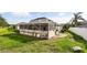 Backyard showing screened patio and lush green lawn at 3824 Blue Dasher Dr, Kissimmee, FL 34744