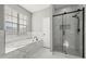 Modern bathroom with separate tub and marble tile shower enclosure at 3824 Blue Dasher Dr, Kissimmee, FL 34744