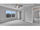 Spacious bedroom features large window, neutral carpet, and walk-in closet at 3824 Blue Dasher Dr, Kissimmee, FL 34744