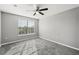 Bedroom featuring gray walls, carpet, window, and a ceiling fan at 3824 Blue Dasher Dr, Kissimmee, FL 34744
