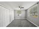 Bedroom features gray walls, carpet, window, ceiling fan, and a closet at 3824 Blue Dasher Dr, Kissimmee, FL 34744