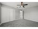 Spacious bedroom featuring gray walls, carpet, ceiling fan, and a closet at 3824 Blue Dasher Dr, Kissimmee, FL 34744