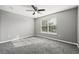 Bright bedroom features large window, ceiling fan, and plush carpet at 3824 Blue Dasher Dr, Kissimmee, FL 34744