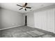 Spacious bedroom featuring gray walls, carpet, ceiling fan, and a closet at 3824 Blue Dasher Dr, Kissimmee, FL 34744