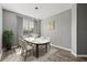 Modern dining room with wood floors, neutral paint, statement light fixture and lots of natural light at 3824 Blue Dasher Dr, Kissimmee, FL 34744