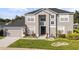 Charming two-story home with landscaped yard, black roof, neutral paint and two car garage at 3824 Blue Dasher Dr, Kissimmee, FL 34744