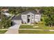 Charming two-story home with landscaped yard, black roof, neutral paint and two car garage at 3824 Blue Dasher Dr, Kissimmee, FL 34744