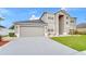 Charming home featuring a two-car garage and well-maintained landscaping at 3824 Blue Dasher Dr, Kissimmee, FL 34744