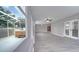 Bright living room with wood look floors, access to a screened-in porch with a hot tub at 3824 Blue Dasher Dr, Kissimmee, FL 34744