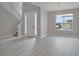 Open living area with new floors, a chandelier, and a large window at 3824 Blue Dasher Dr, Kissimmee, FL 34744