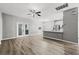Open-concept living room has stylish ceiling fan and doors to the outside at 3824 Blue Dasher Dr, Kissimmee, FL 34744