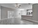 Open floor plan with gray walls and wood look floors, connecting the living and kitchen areas at 3824 Blue Dasher Dr, Kissimmee, FL 34744