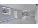 Large, airy living room featuring wood look floors, neutral gray walls, and ample natural light at 3824 Blue Dasher Dr, Kissimmee, FL 34744